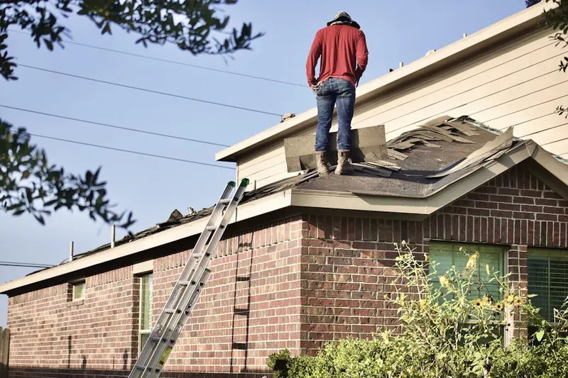 Professional roofer working on a residential roof in West Elkton